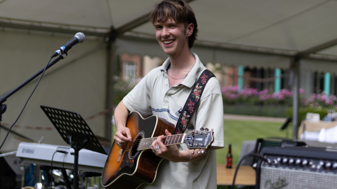 A student performing at Homerton's annual garden party