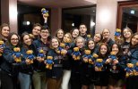 20 visiting Ukrainian medical students posing with Cambridge University hoodies and Homerton College teddy bears